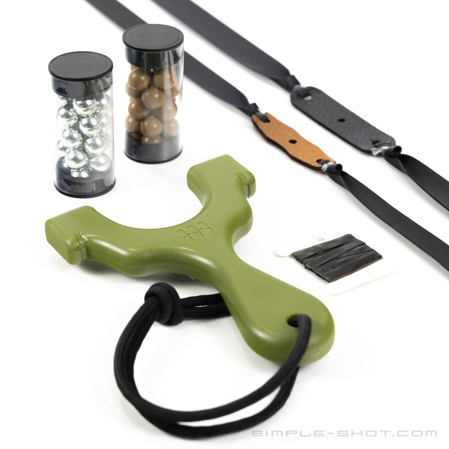 The Axiom Champ slingshot, showcasing a compact design, is available in olive-green with a black wrist strap. It comes with two tubes of steel and clay pellets, replacement rubber bands equipped with a microfiber pouch, and a small packet of black tape—ideal for minimalist gear enthusiasts.